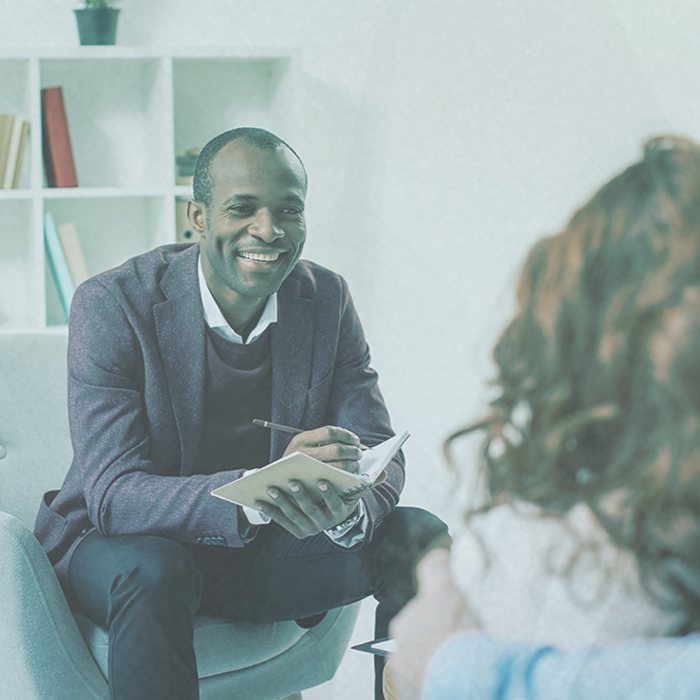 Male therapist smiling with client