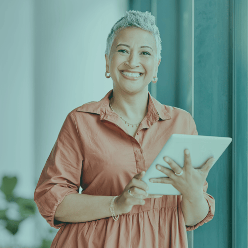 Woman smiling holding a tablet