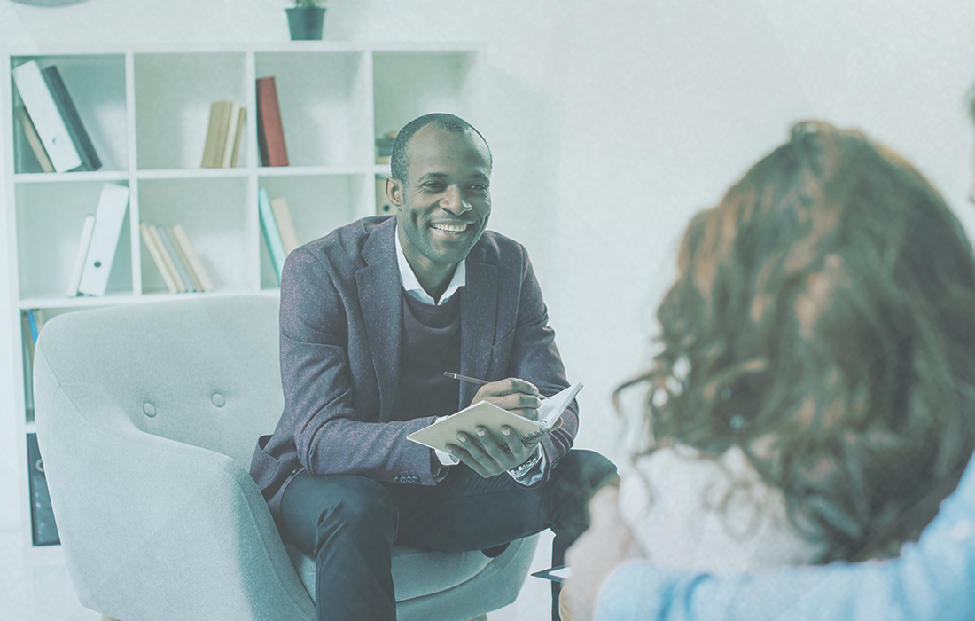 Male therapist smiling with client