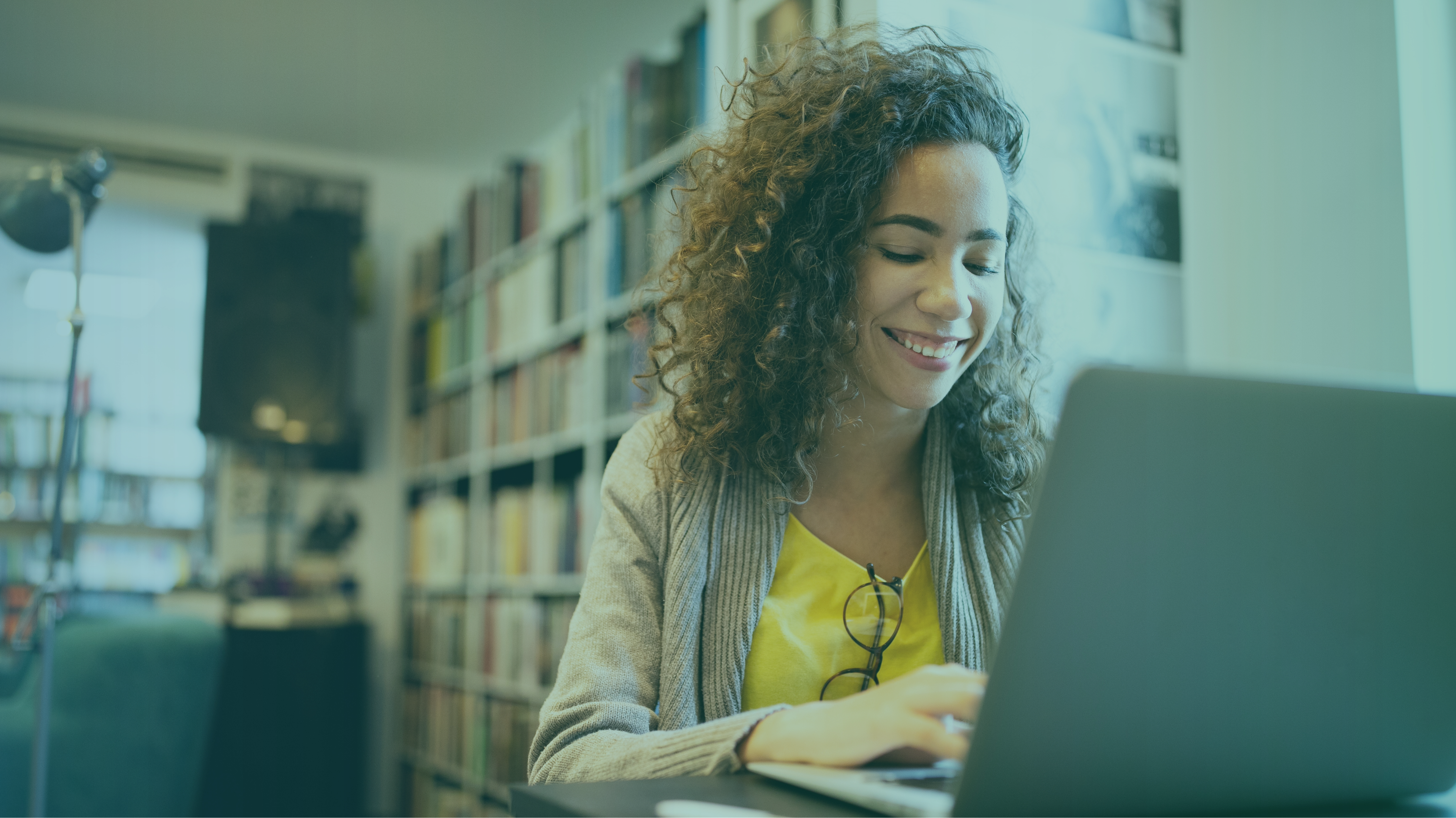 Woman smiling while working on computer