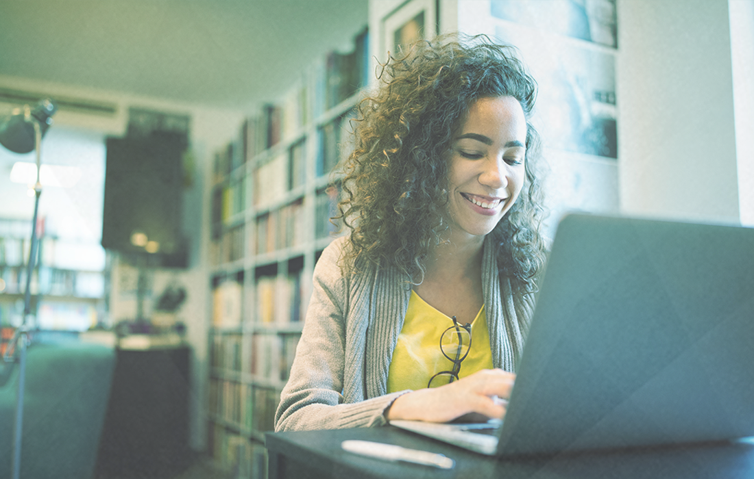 Woman smiling at laptop